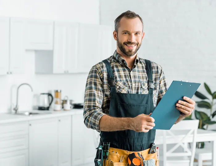 appliance technician man holding a checklist