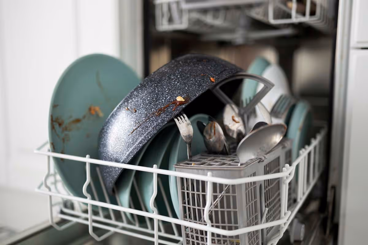 Featured Blog: A woman looking at a dishwasher