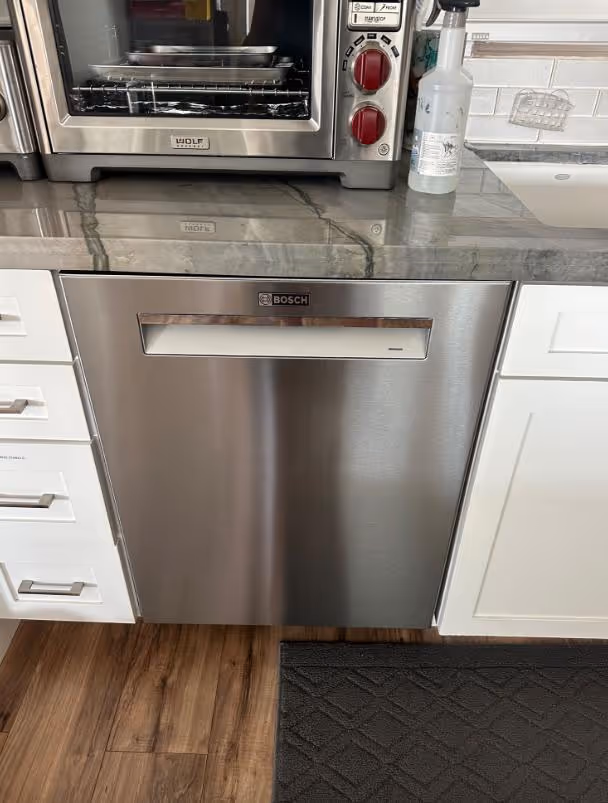 Featured Blog: A woman looking at a dishwasher