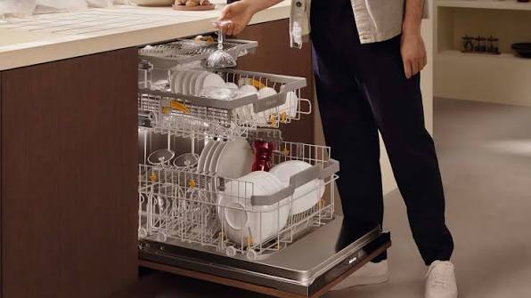 Featured Blog: A woman looking at a dishwasher